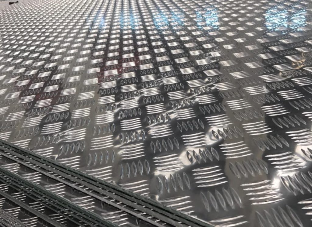 An aluminium plate with a chequered pattern.